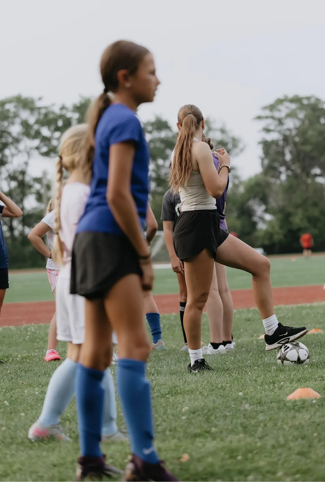 Mary coaching young players on the field