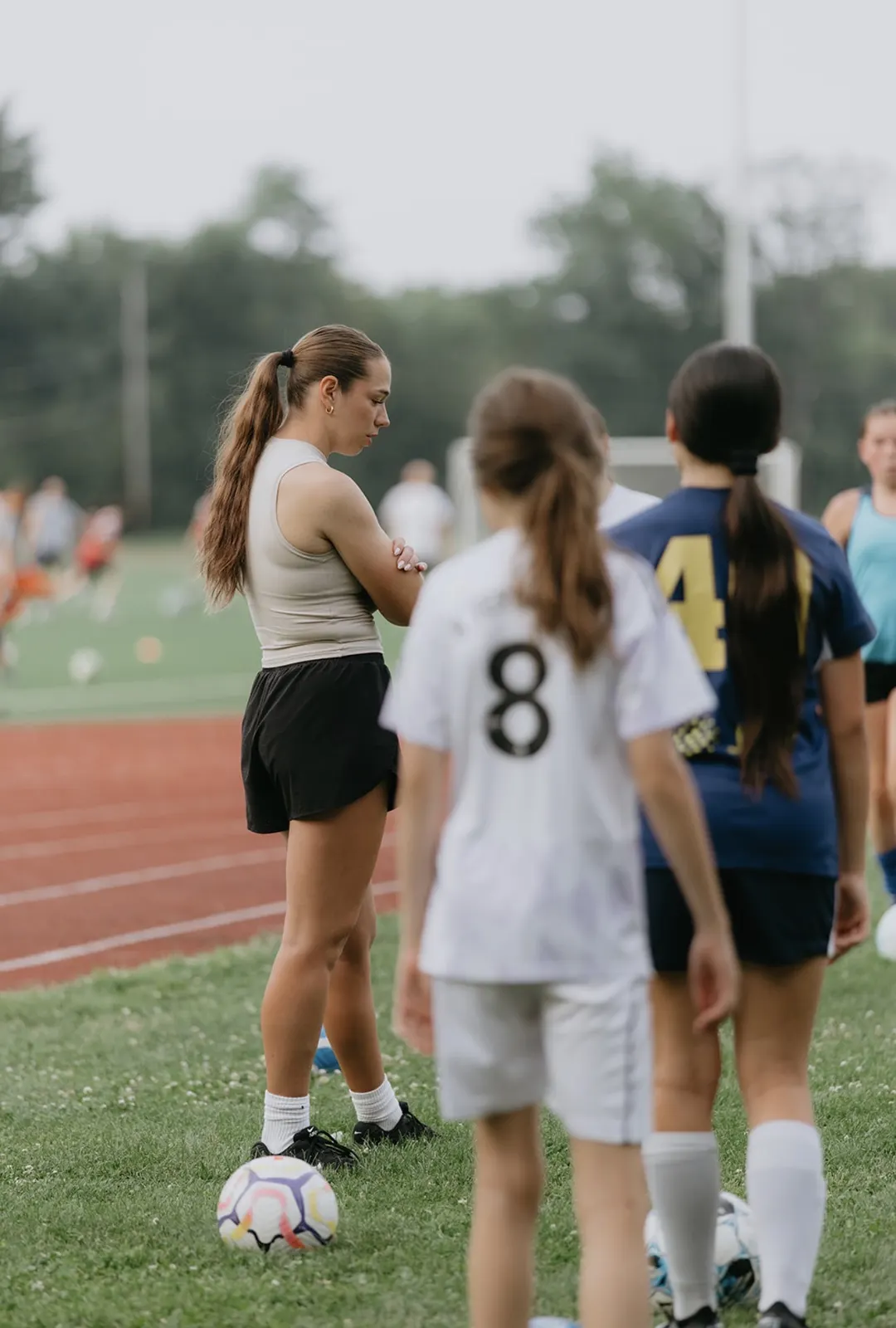Mary coaching a group of youth soccer players